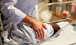 Newborn in hospital crib